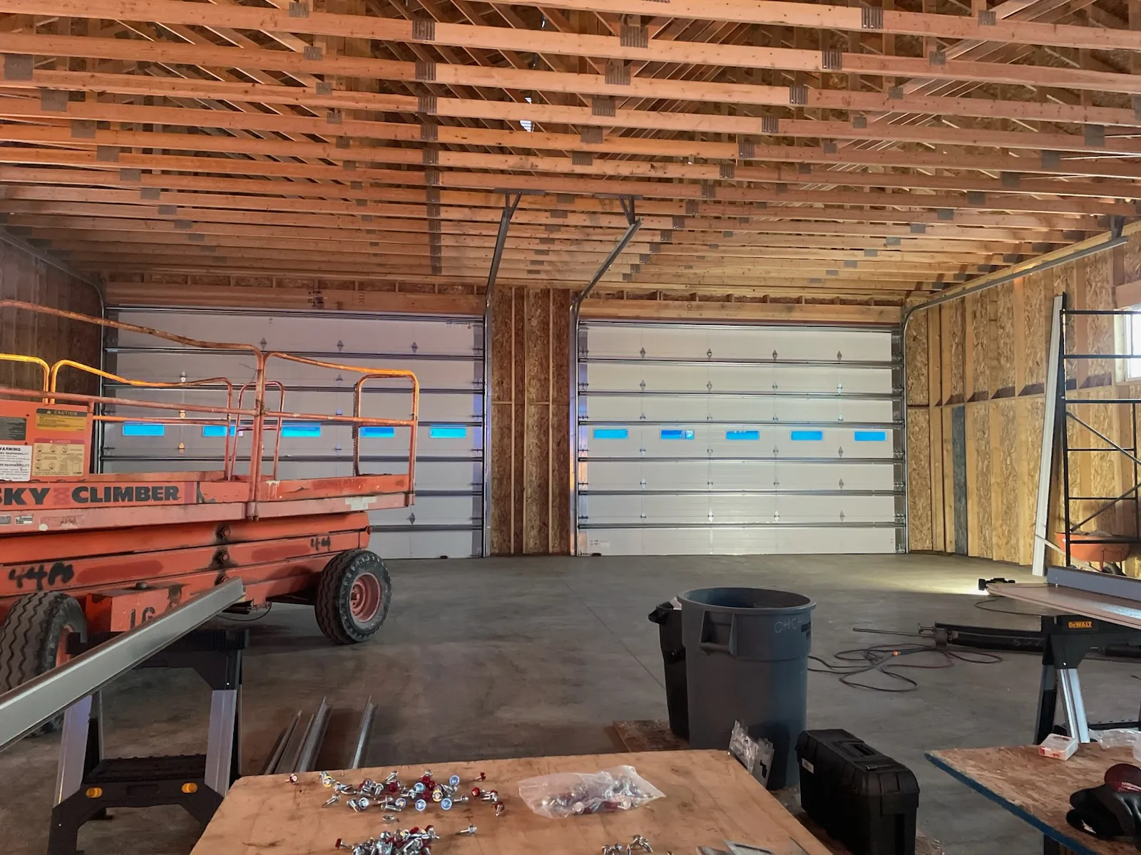 Interior of a new garage with multiple sectional doors and installation equipment